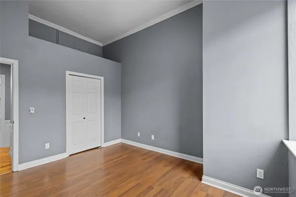 a view of an empty room with wooden floor