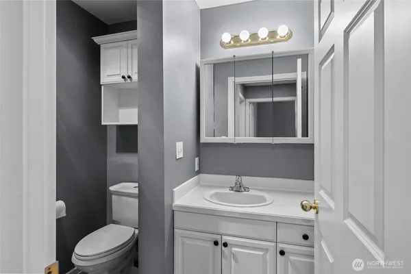 a bathroom with a sink toilet vanity and tub
