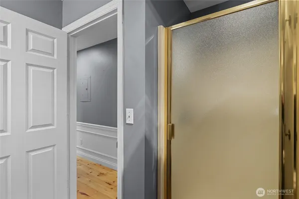 a bathroom with a glass shower door