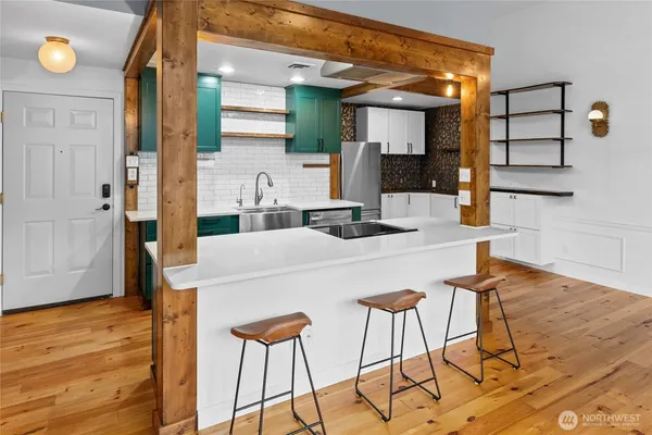 a kitchen with a table and chairs