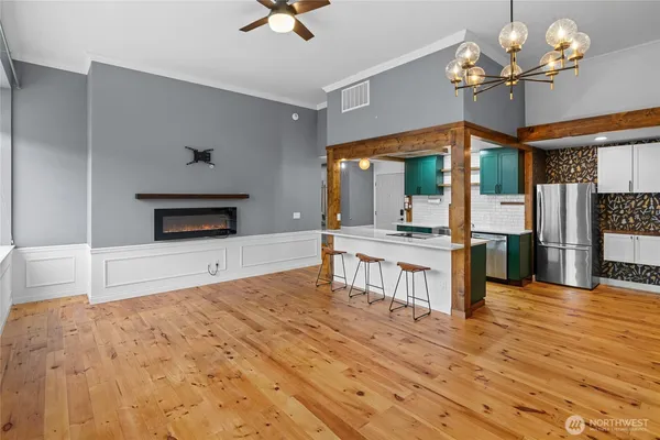 a living room with fireplace furniture and a wooden floor