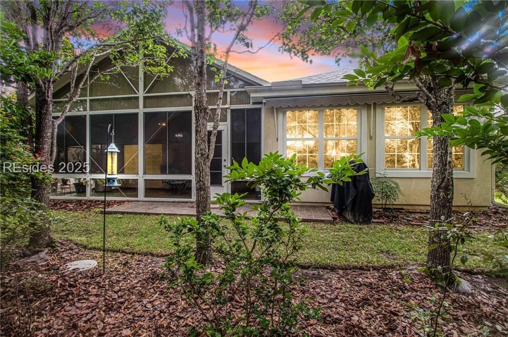 22 Sundome Court Bluffton, SC 29909 - Photo 2 of 35 Screened Lanai, vinyl windows, paver patio