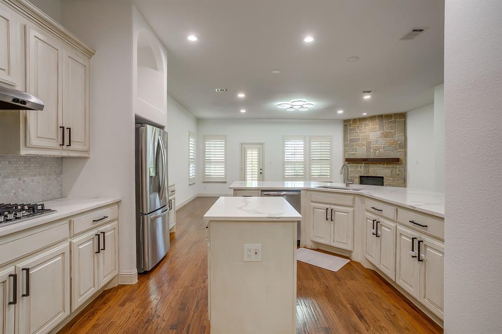 3009 Montebello Drive Denton, TX 76210 - Photo 13 of 38 a kitchen with stainless steel appliances granite countertop a sink stove and refrigerator