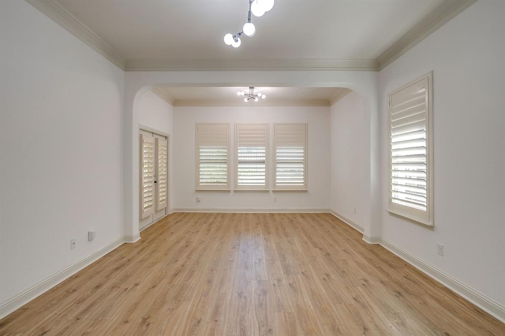 3009 Montebello Drive Denton, TX 76210 - Photo 17 of 38 an empty room with wooden floor and windows