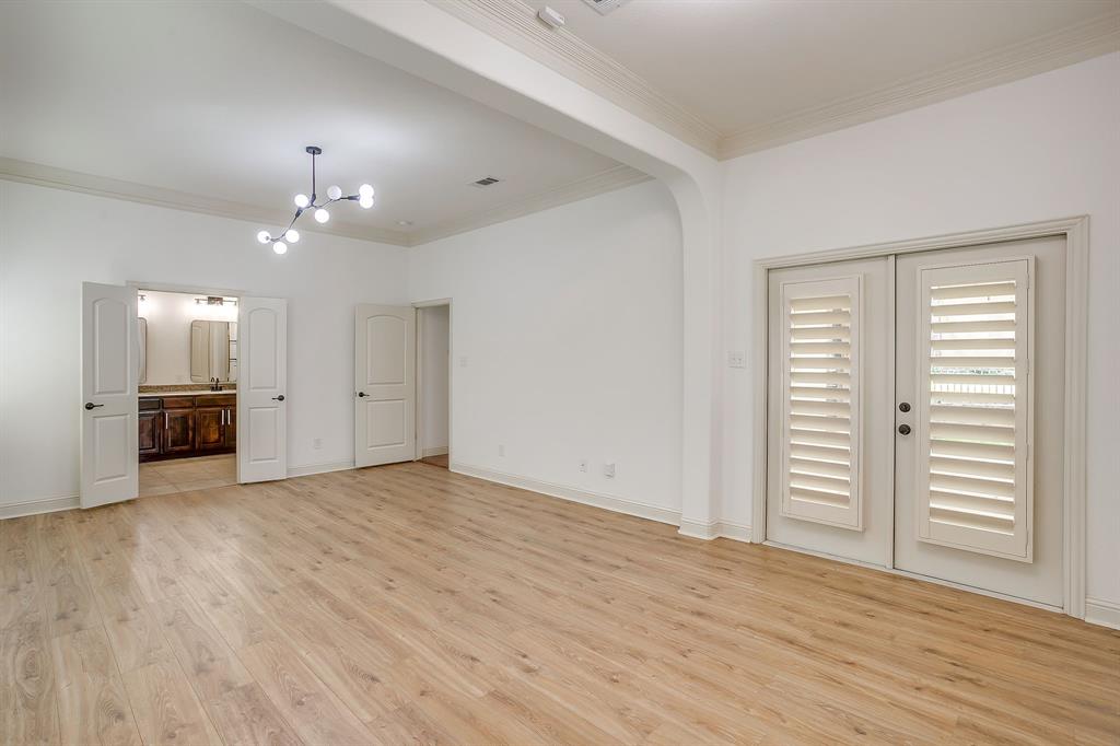3009 Montebello Drive Denton, TX 76210 - Photo 18 of 38 an empty room with wooden floor cabinet and windows