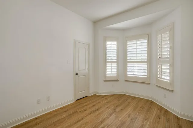 a view of an empty room and wooden floor