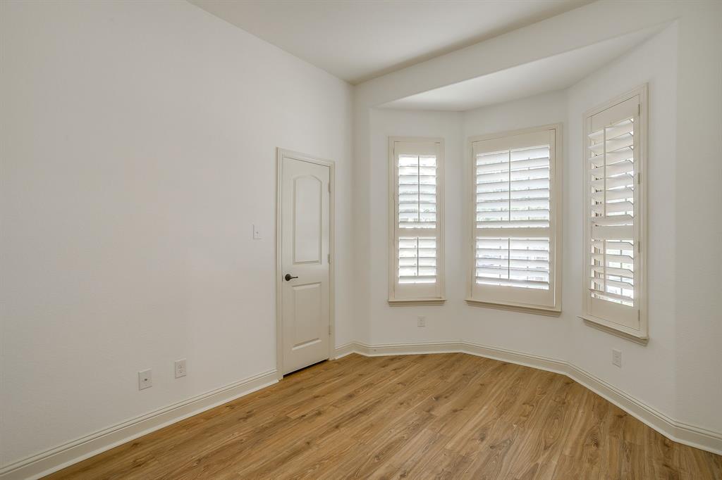 3009 Montebello Drive Denton, TX 76210 - Photo 29 of 38 an empty room with wooden floor and windows