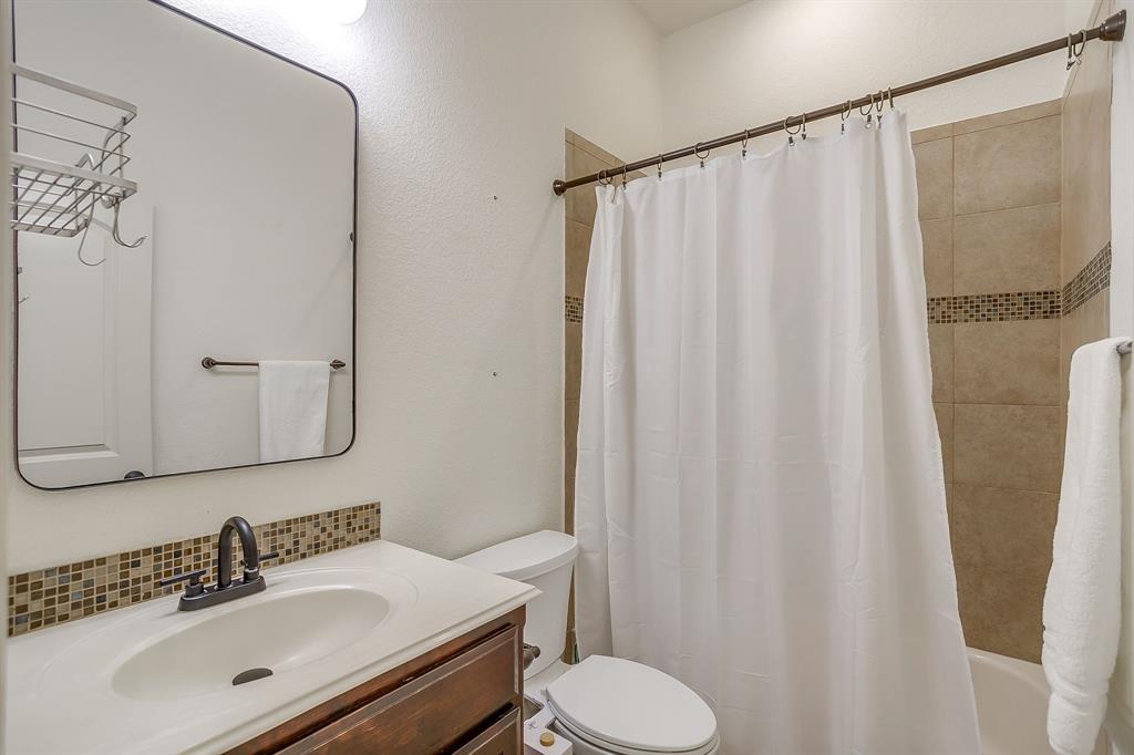 3009 Montebello Drive Denton, TX 76210 - Photo 31 of 38 a bathroom with a sink and a mirror