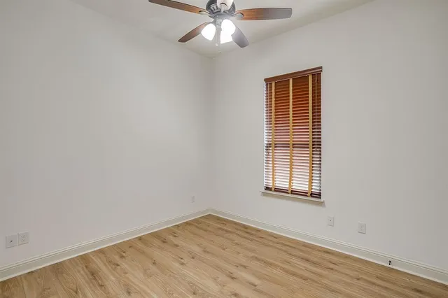 a view of an empty room and wooden floor