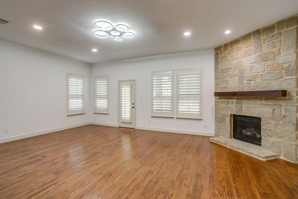 3009 Montebello Drive Denton, TX 76210 - Photo 7 of 38 a view of an empty room with a fireplace and a window