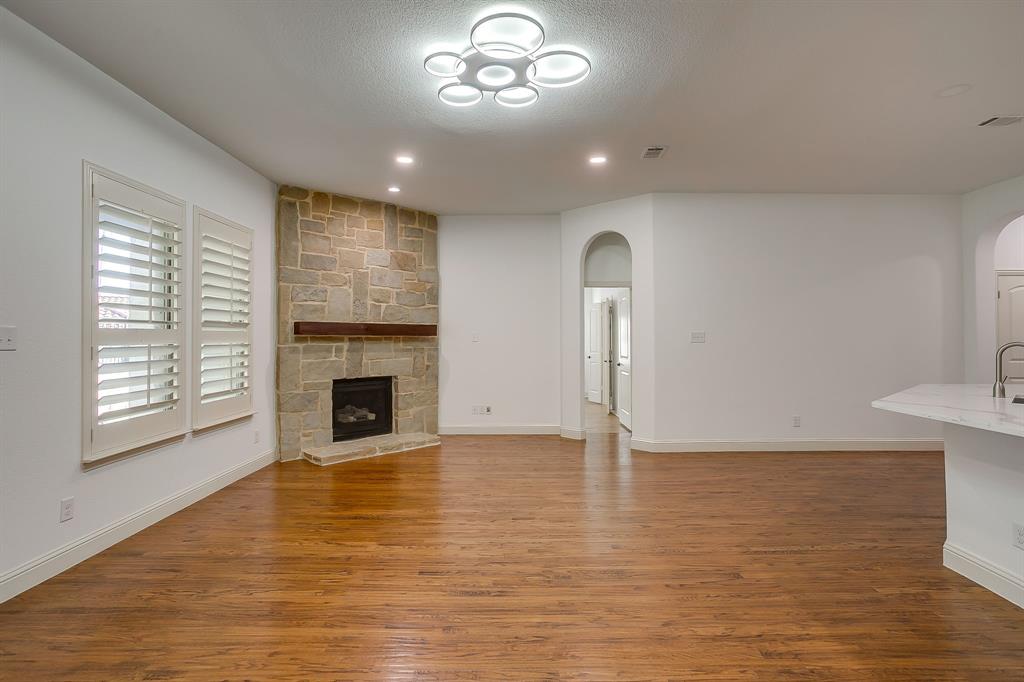 3009 Montebello Drive Denton, TX 76210 - Photo 10 of 38 a view of a livingroom with a fireplace window and wooden floor