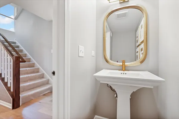 a room with a sink and mirror