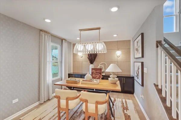 a view of a dining room with furniture a chandelier and wooden floor