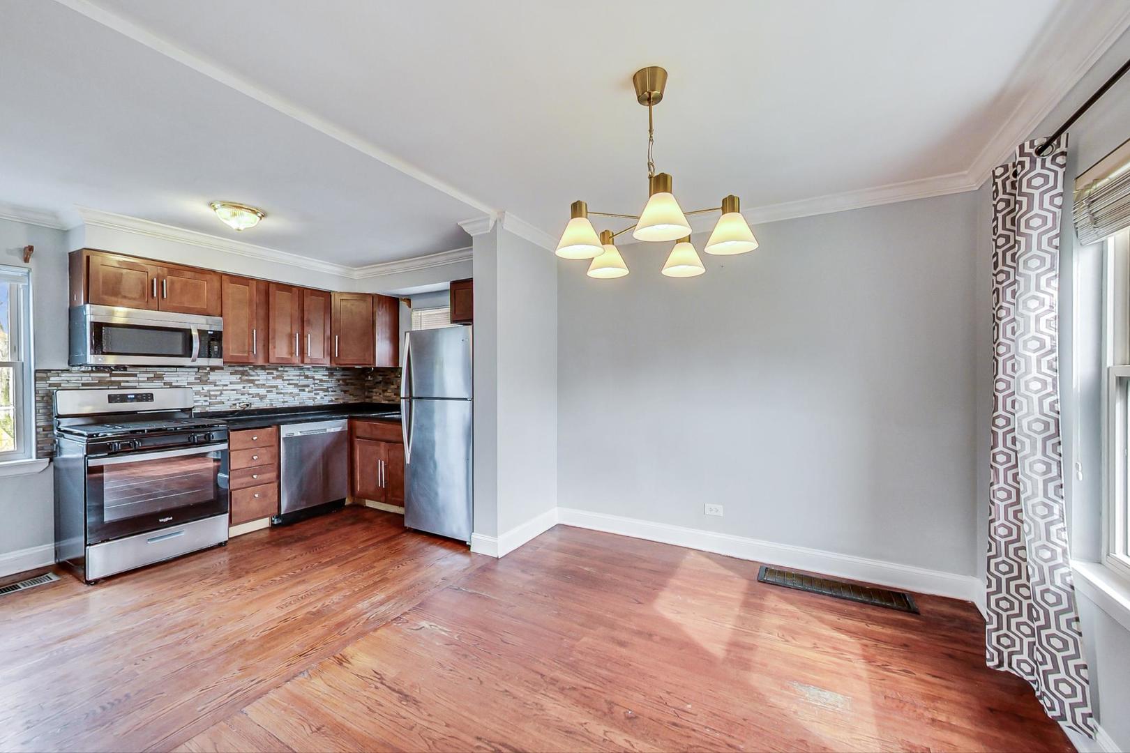 402 North Main Street Mount Prospect, IL 60056 - Photo 8 of 19 a kitchen with stainless steel appliances granite countertop a stove a refrigerator and a wooden floors