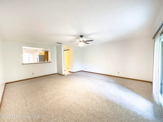 an empty room with a empty space and windows