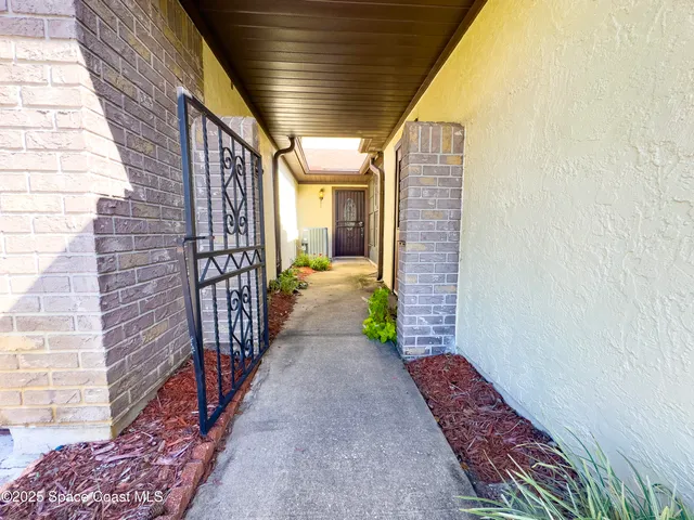 a view of a pathway of a house with wooden stairs