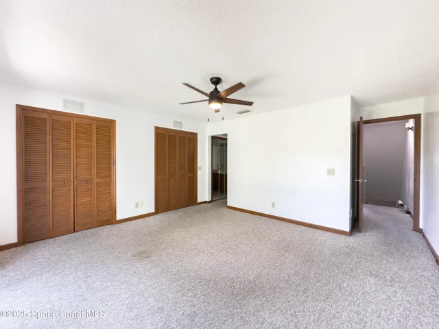 a view of a hallway to room with window and entryway