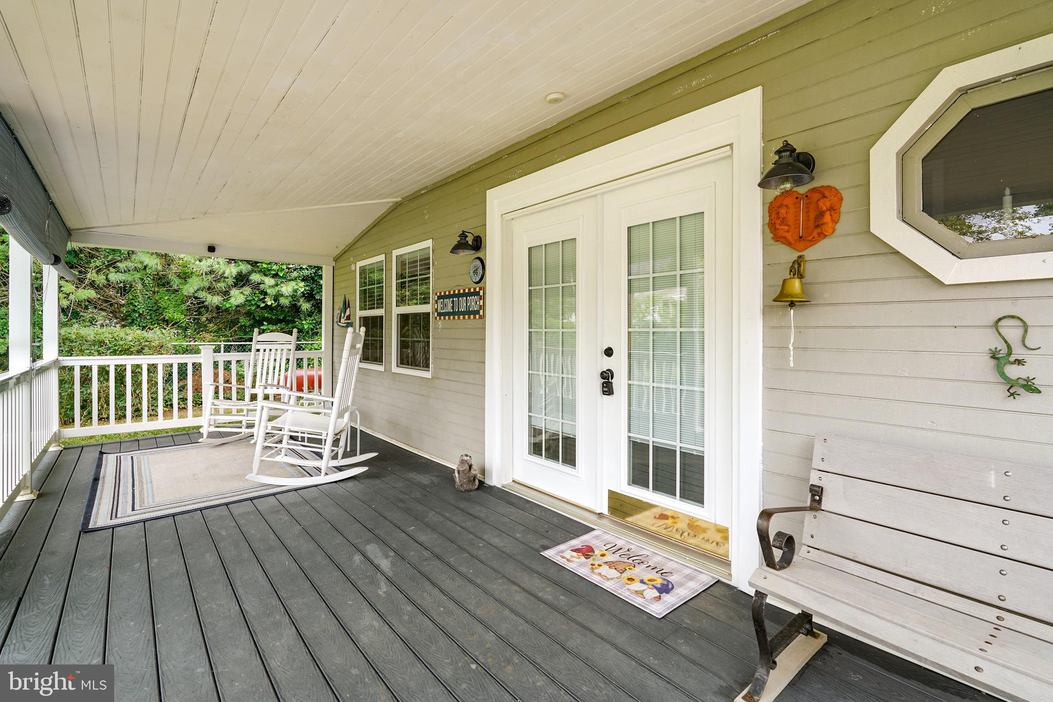78 Riverview Avenue Earleville, MD 21919 - Photo 5 of 36 a balcony with wooden floor table and chairs