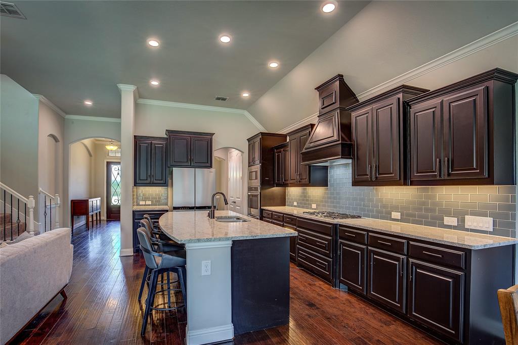 a kitchen with stainless steel appliances kitchen island granite countertop a sink and cabinets