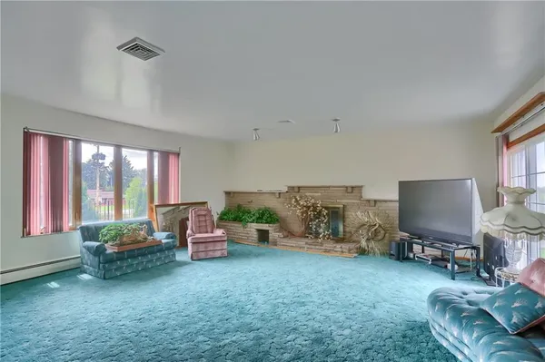 a view of a room that has a bed and a chandelier in it