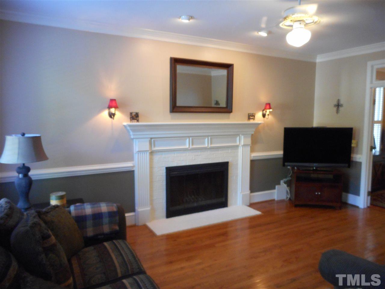 6809 Chasewick Circle Raleigh, NC 27615 - Photo 13 of 23 The large living room continues the lovely moldings, hardwoods, 9 foot smooth ceilings, and neutral colors found throughout the downstairs. And yes, a wood burning fireplace.