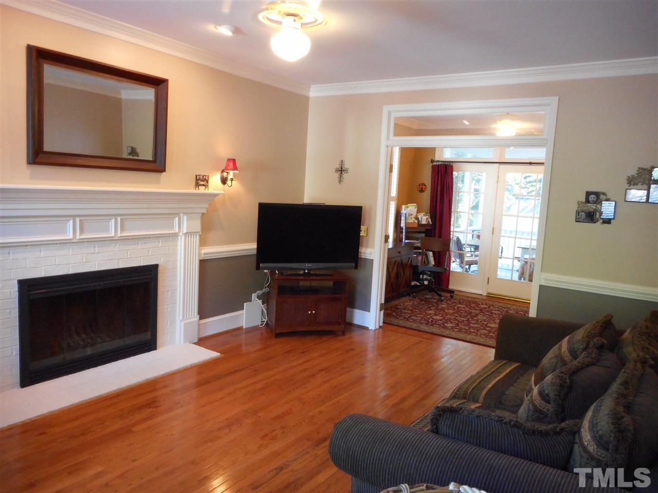 6809 Chasewick Circle Raleigh, NC 27615 - Photo 14 of 23 Living room access to the office is through french doors topped with a transom, continuing the open and light design.