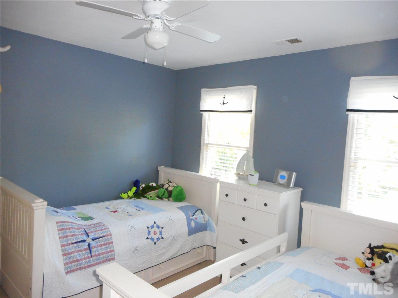 6809 Chasewick Circle Raleigh, NC 27615 - Photo 21 of 23 All the bedrooms have ceiling fans, smooth ceilings, neutral paint. And again, this one has 2 windows and a good closet.