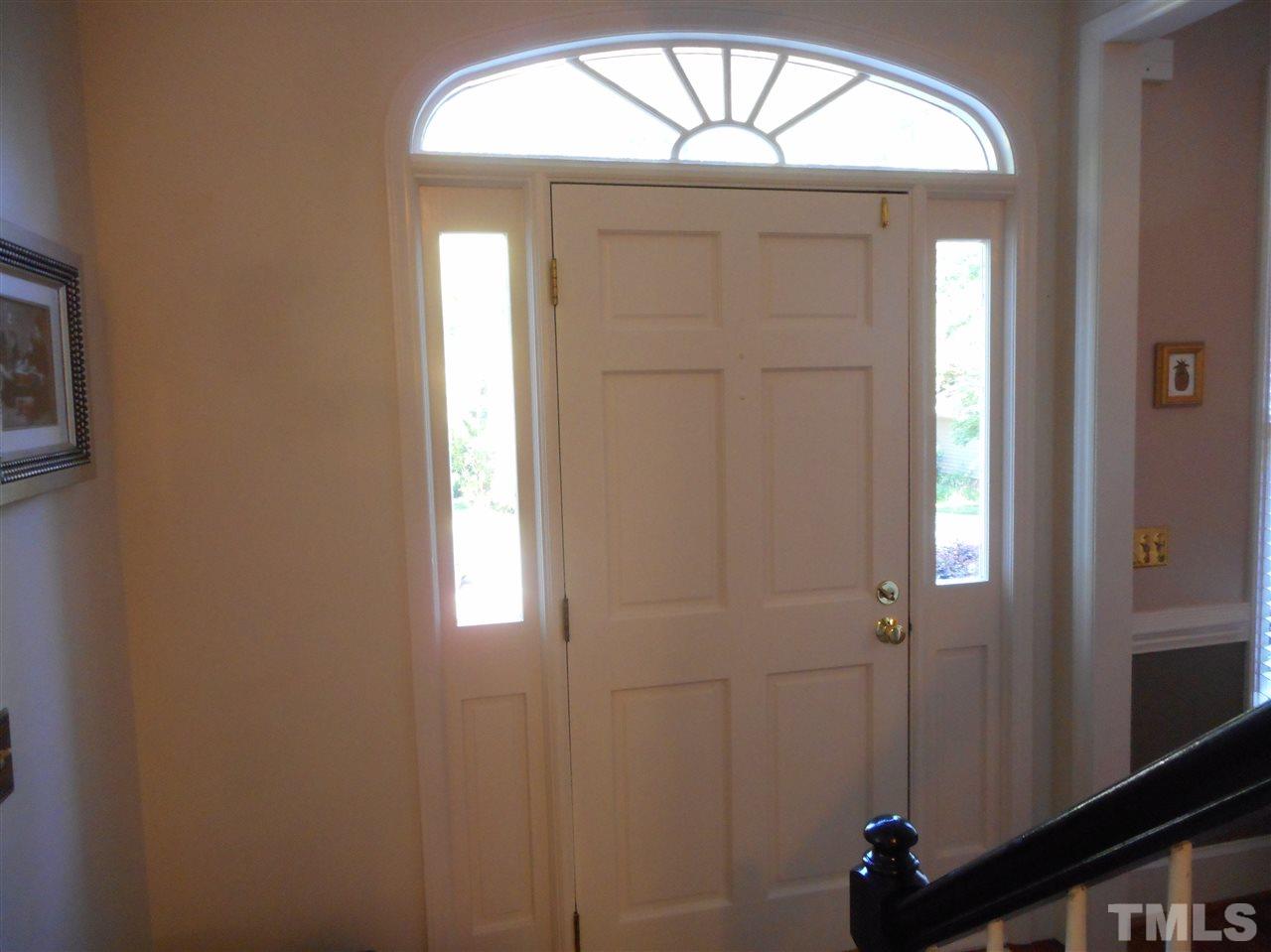 6809 Chasewick Circle Raleigh, NC 27615 - Photo 7 of 23 Come on in! Enjoy the many architectural details, starting with transoms, door side lights, crown and chair rail moldings, even lighted stairway to the second floor!