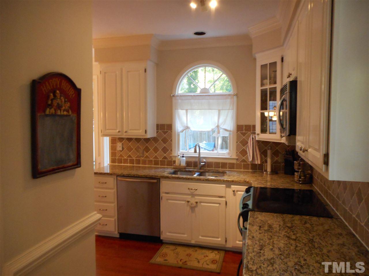 6809 Chasewick Circle Raleigh, NC 27615 - Photo 9 of 23 Coming in from the dining room, side door entry on your right, pantry on the left, welcome home!