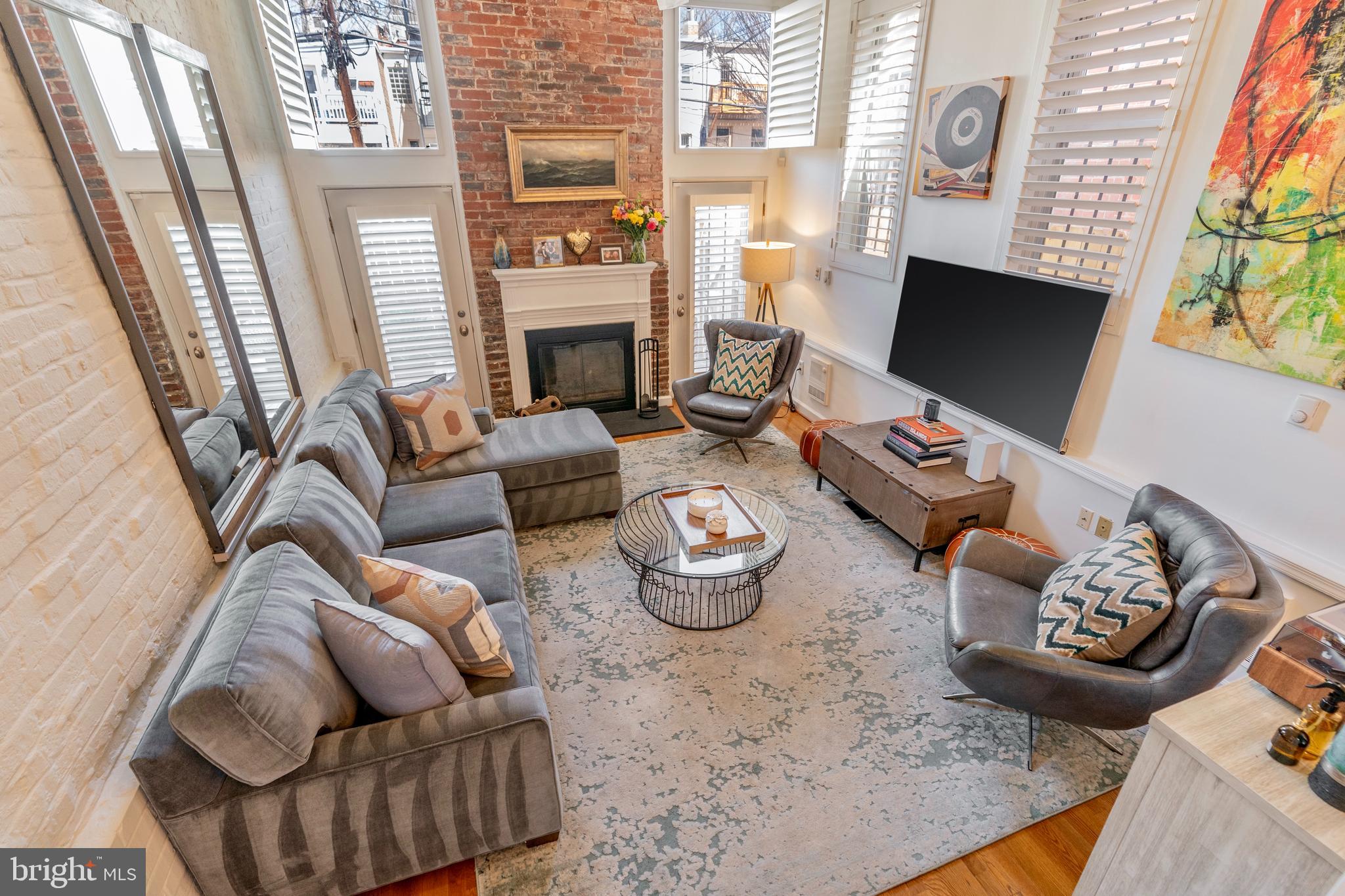 a living room with furniture fireplace and a flat screen tv