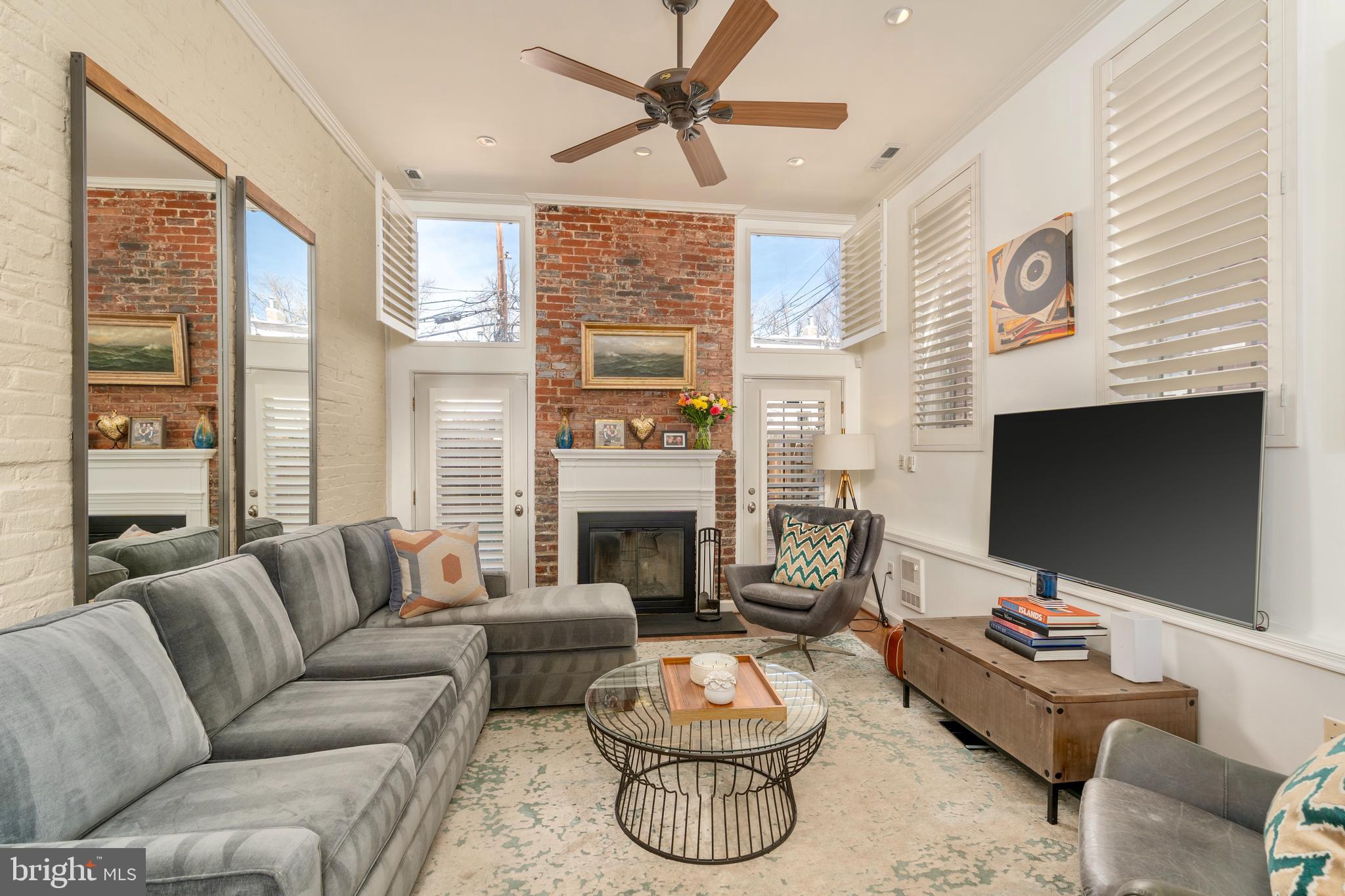 1433 S Street Northwest, Unit 2 Washington, DC 20009 - Photo 13 of 44 a living room with furniture a fireplace and a flat screen tv