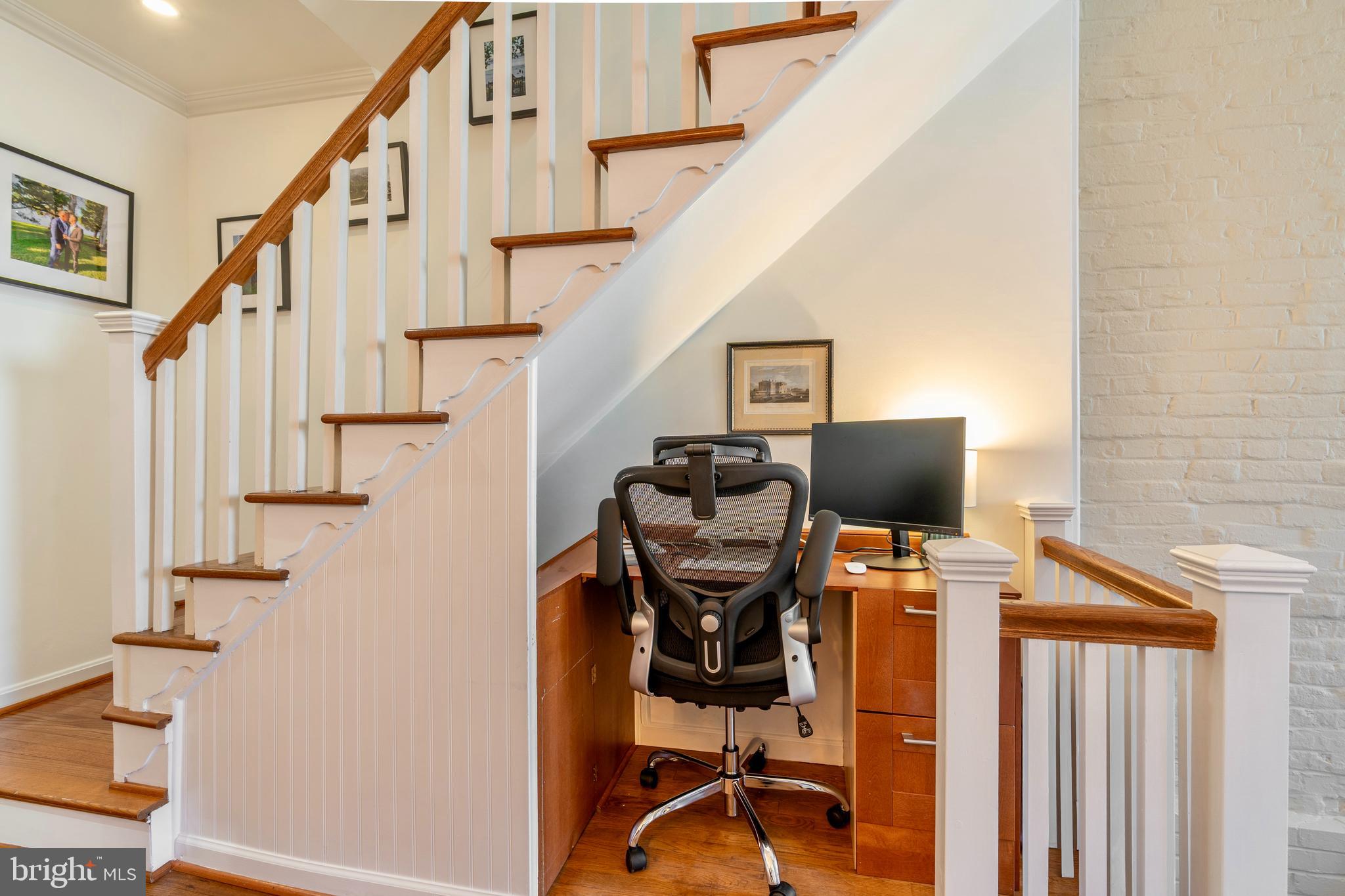 1433 S Street Northwest, Unit 2 Washington, DC 20009 - Photo 20 of 44 a view of a workspace with wooden floor and stairs