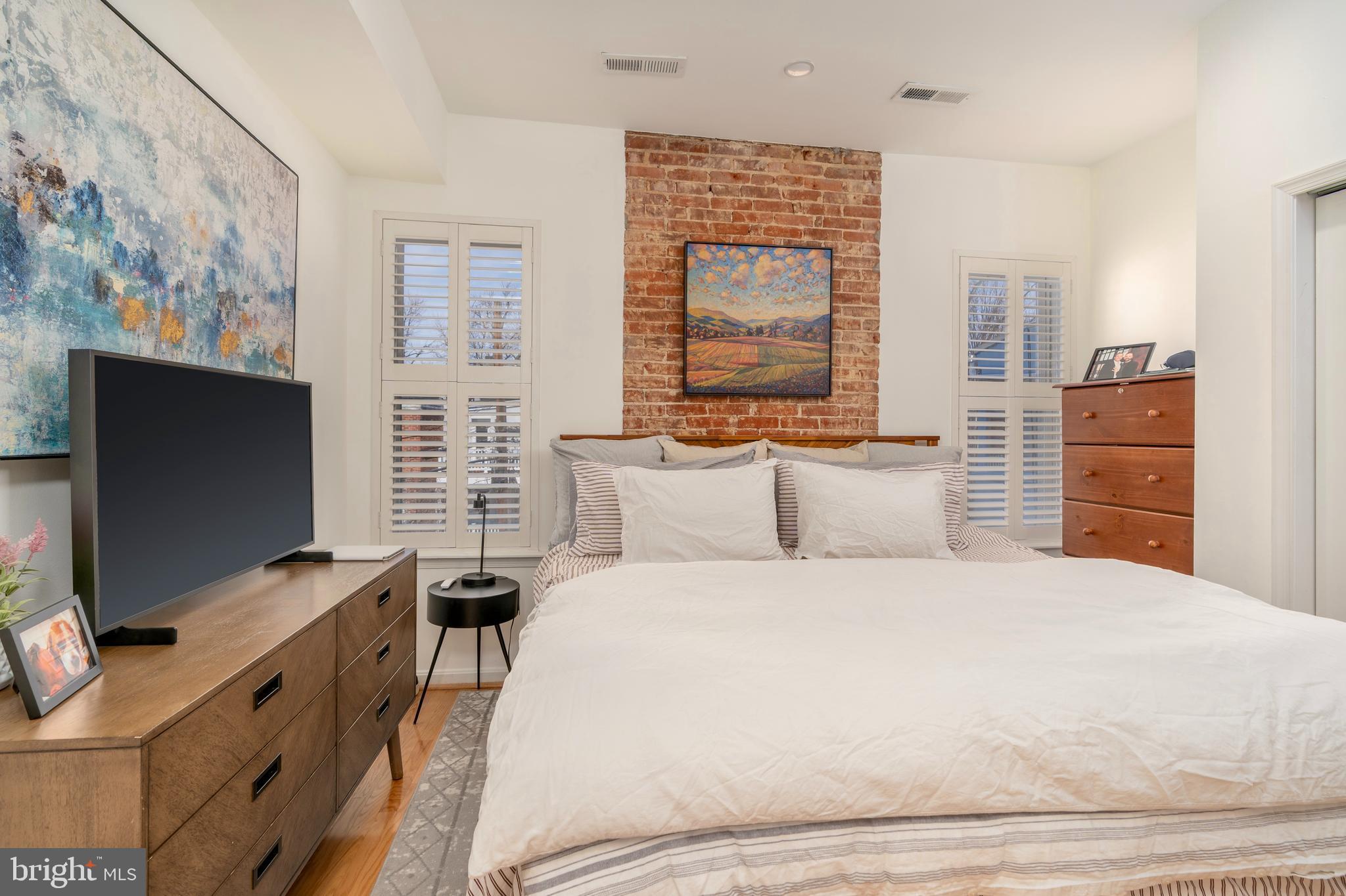 1433 S Street Northwest, Unit 2 Washington, DC 20009 - Photo 27 of 44 a bedroom with a bed and a flat screen tv