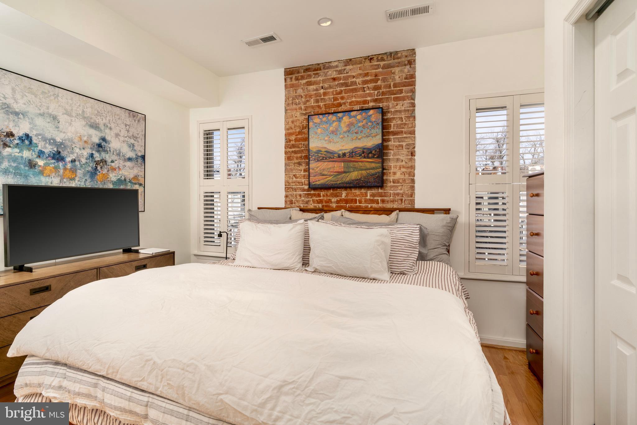 1433 S Street Northwest, Unit 2 Washington, DC 20009 - Photo 28 of 44 a bedroom with a bed window and a flat screen tv