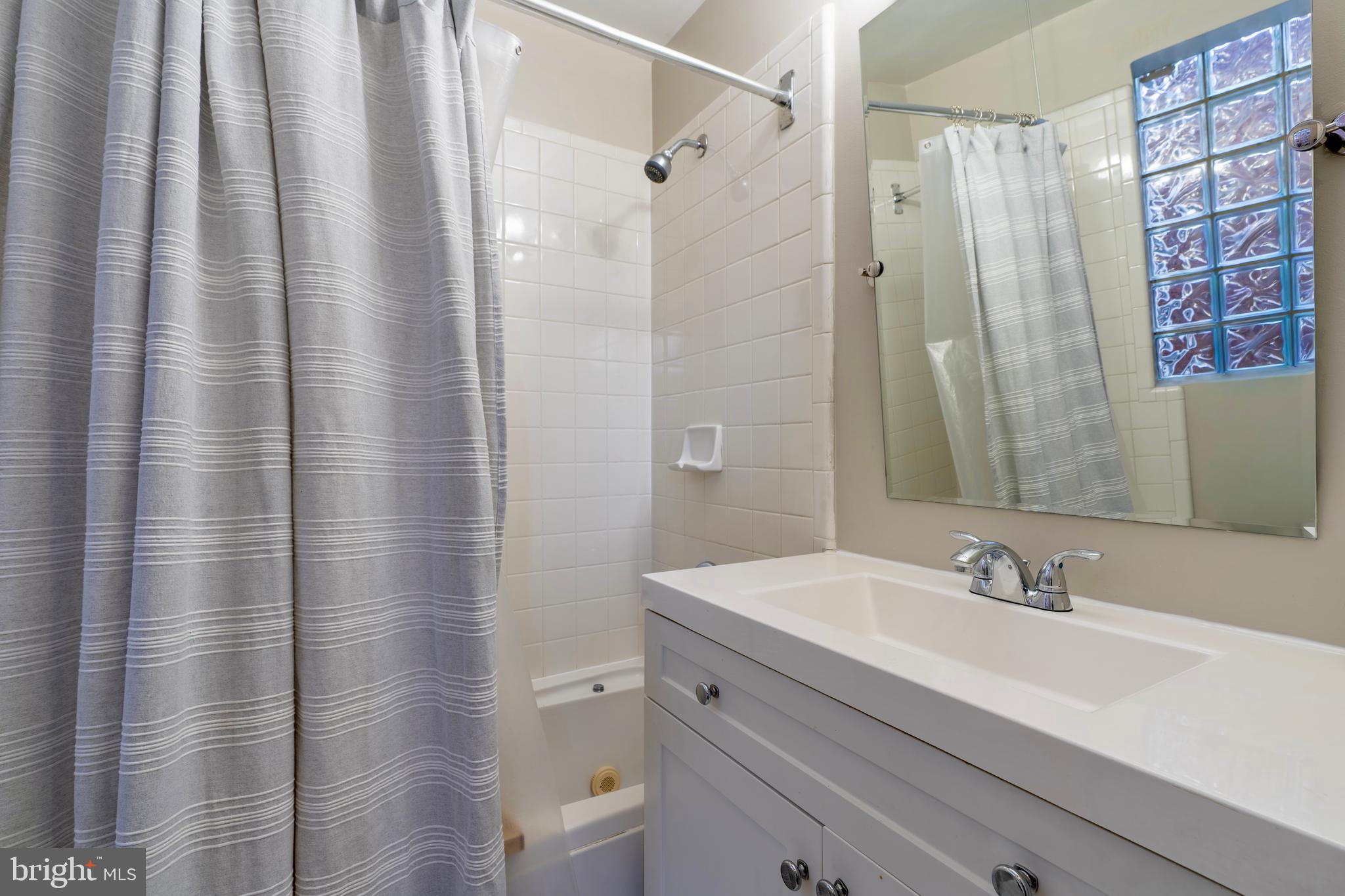 1433 S Street Northwest, Unit 2 Washington, DC 20009 - Photo 36 of 44 a bathroom with a sink and a mirror