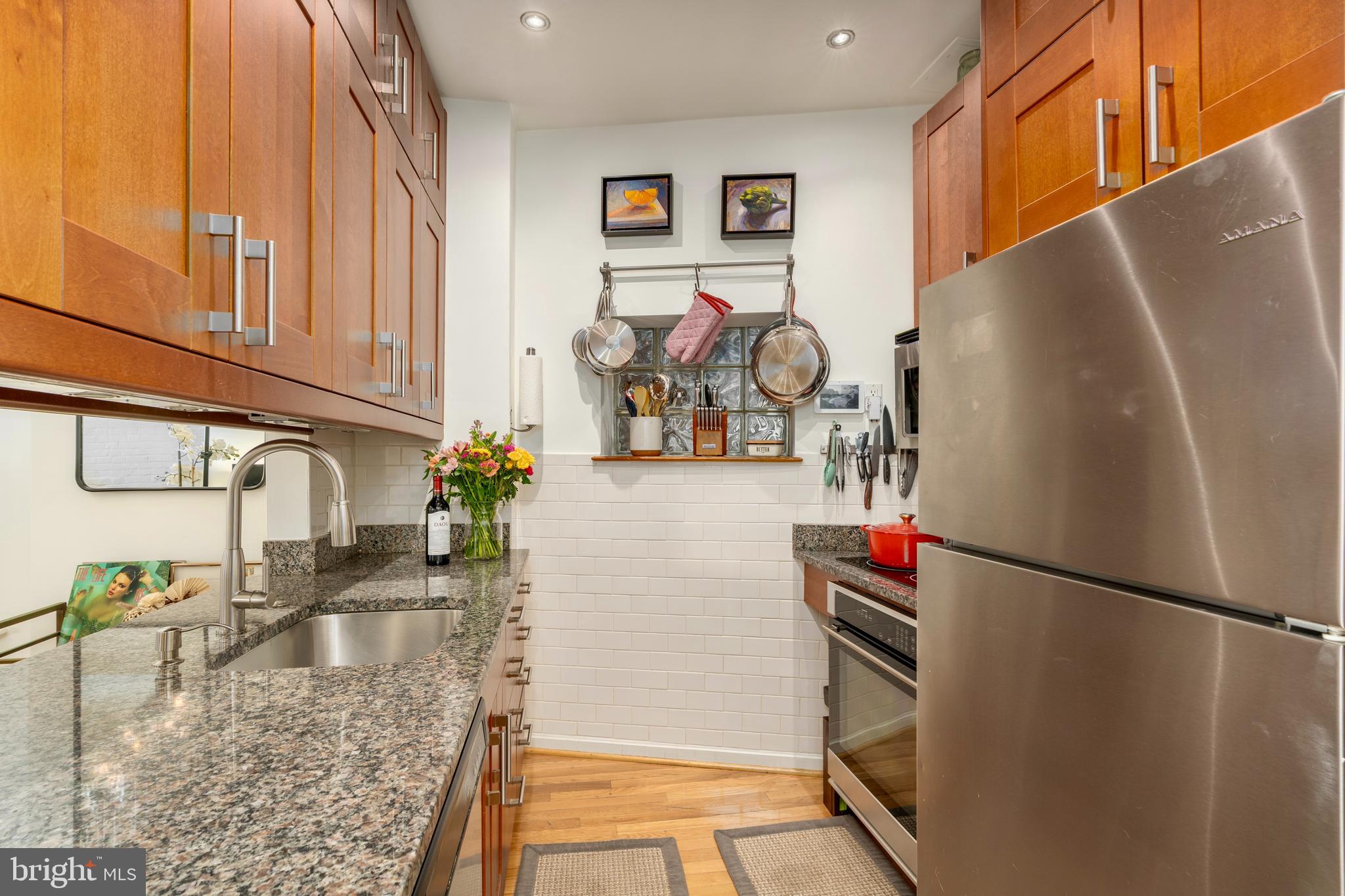 1433 S Street Northwest, Unit 2 Washington, DC 20009 - Photo 5 of 44 a kitchen with stainless steel appliances granite countertop a refrigerator and a sink