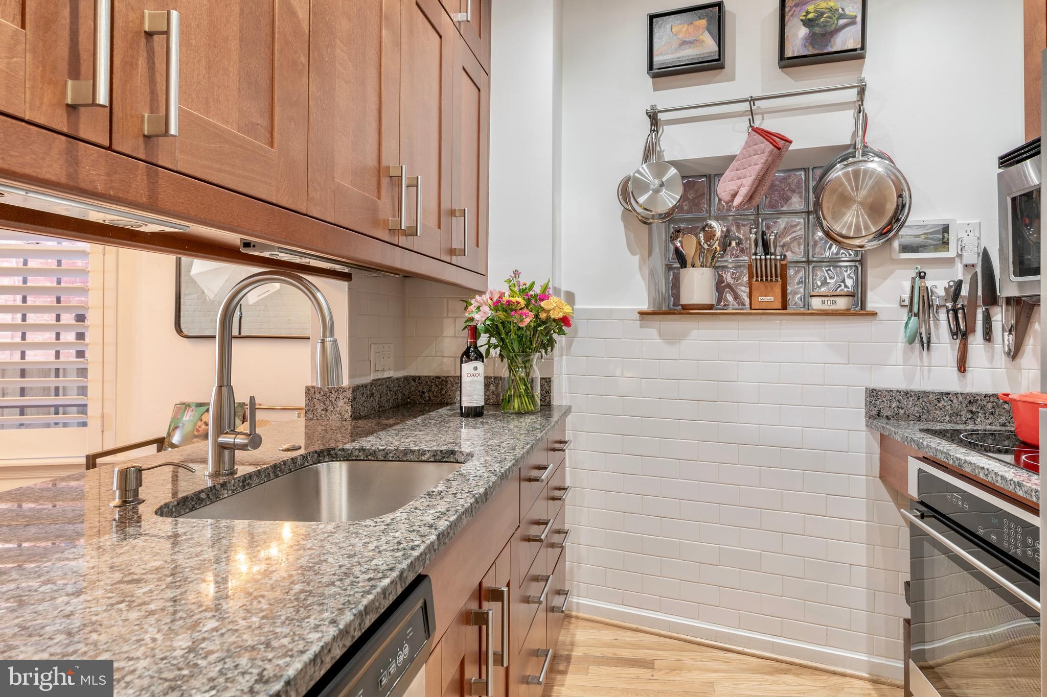 1433 S Street Northwest, Unit 2 Washington, DC 20009 - Photo 6 of 44 a kitchen with granite countertop a sink a stove and cabinets