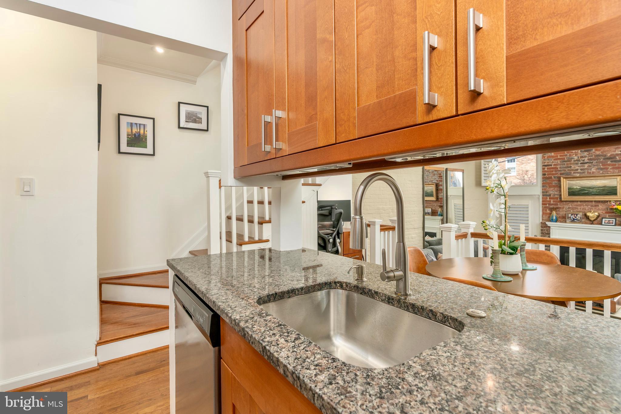 1433 S Street Northwest, Unit 2 Washington, DC 20009 - Photo 7 of 44 a kitchen with granite countertop a sink and wooden floor