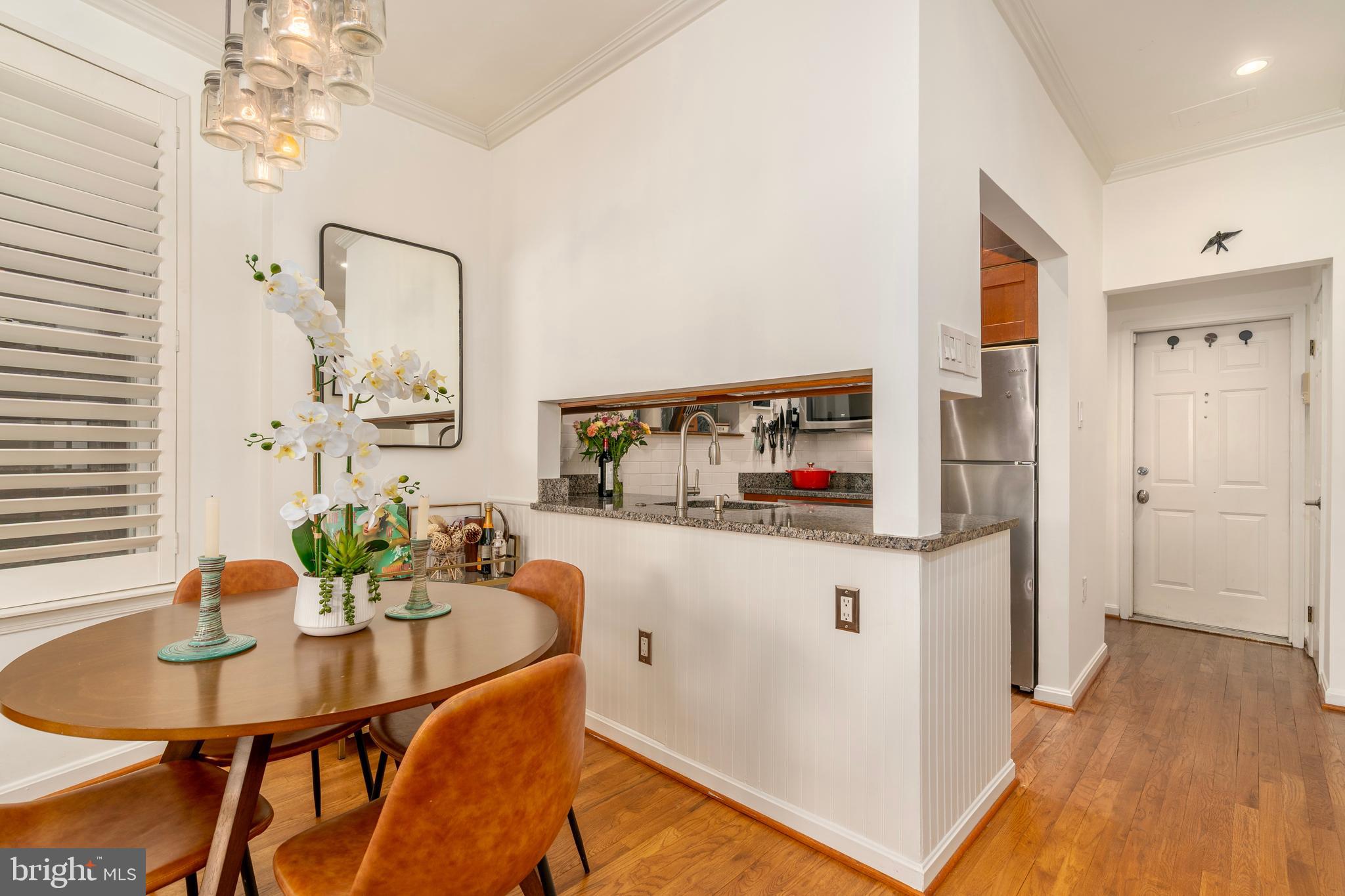 1433 S Street Northwest, Unit 2 Washington, DC 20009 - Photo 10 of 44 a kitchen with stainless steel appliances a dining table and chairs