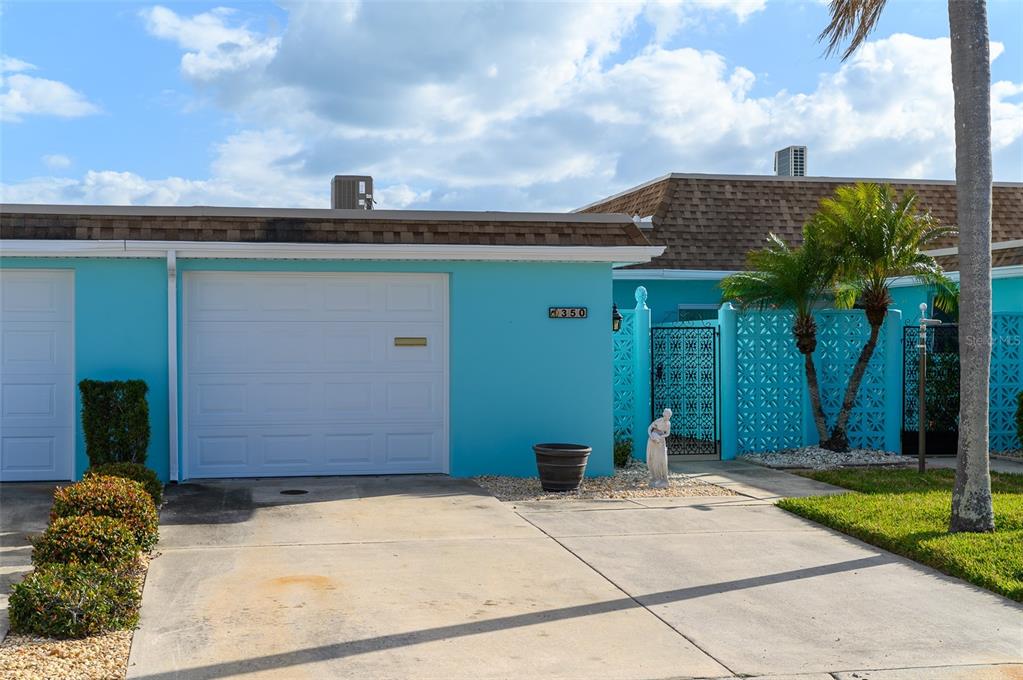350 Boca Ciega Point Boulevard St. Petersburg, FL 33708 - Photo 1 of 32 a front view of a house with garden