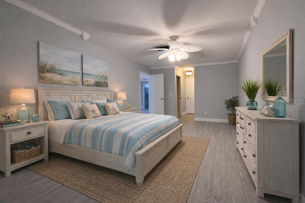 350 Boca Ciega Point Boulevard St. Petersburg, FL 33708 - Photo 13 of 32 a spacious bedroom with a large bed and a chandelier