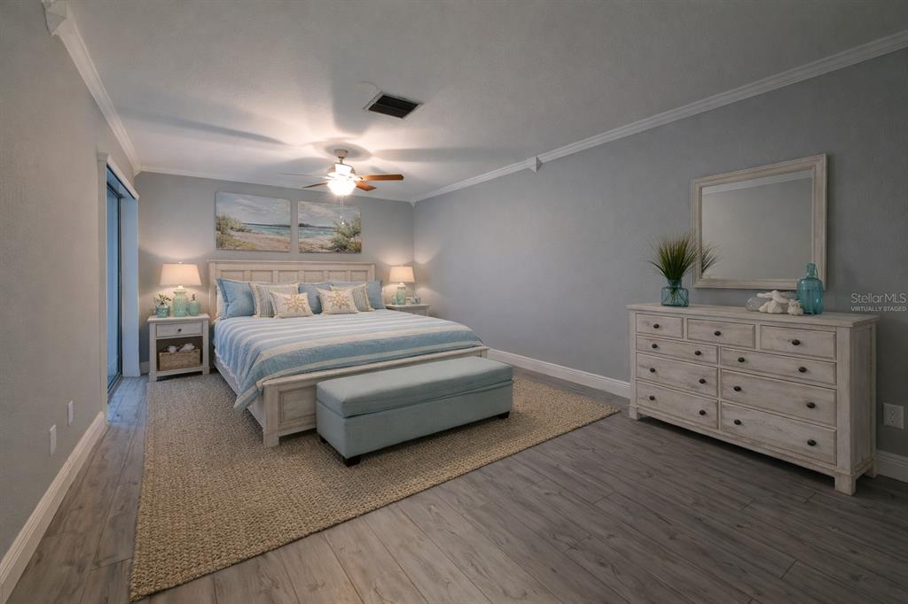 350 Boca Ciega Point Boulevard St. Petersburg, FL 33708 - Photo 15 of 32 a bedroom with a bed and a chandelier