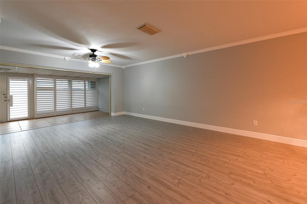 350 Boca Ciega Point Boulevard St. Petersburg, FL 33708 - Photo 2 of 25 wooden floor in an empty room with a window