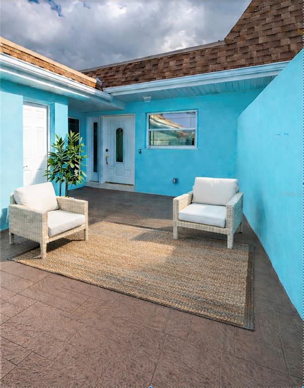 350 Boca Ciega Point Boulevard St. Petersburg, FL 33708 - Photo 2 of 32 a backyard of a house with outdoor seating