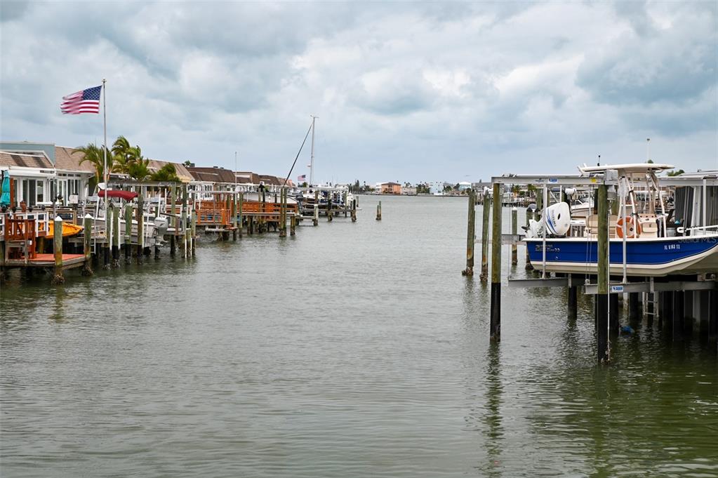 350 Boca Ciega Point Boulevard St. Petersburg, FL 33708 - Photo 23 of 25 a view of a lake with boats and palm trees
