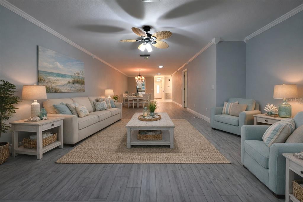 350 Boca Ciega Point Boulevard St. Petersburg, FL 33708 - Photo 5 of 32 a living room with furniture and a chandelier