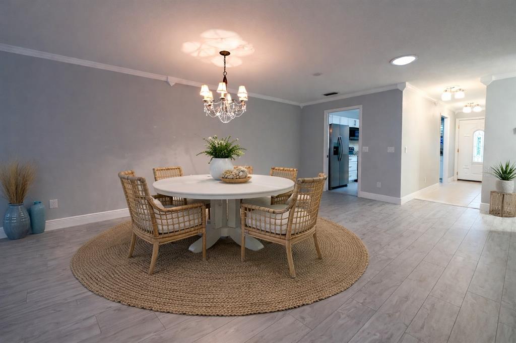 350 Boca Ciega Point Boulevard St. Petersburg, FL 33708 - Photo 7 of 32 a view of a dining room with furniture and wooden floor