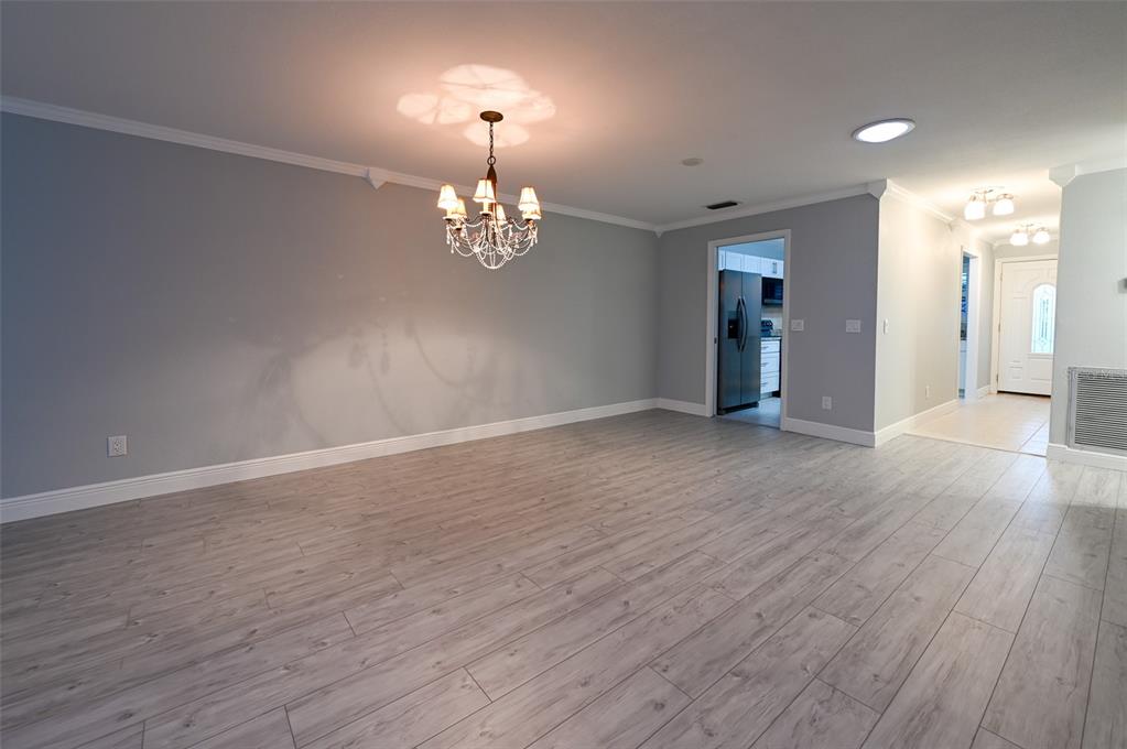 350 Boca Ciega Point Boulevard St. Petersburg, FL 33708 - Photo 7 of 25 wooden floor in an empty room with a window