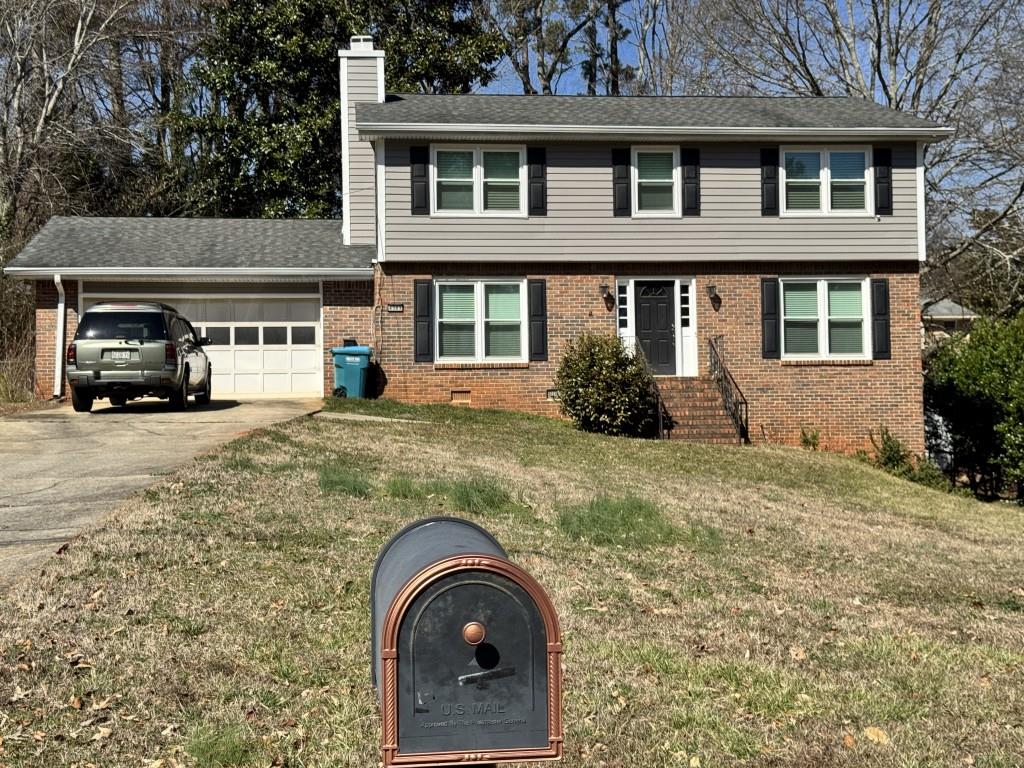 4703 Marc Court Southwest Lilburn, GA 30047 - Photo 2 of 57 a front view of a house with garden