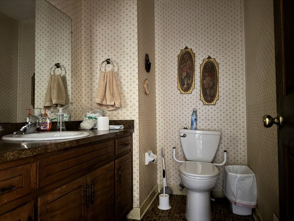 4703 Marc Court Southwest Lilburn, GA 30047 - Photo 24 of 57 a bathroom with a toilet sink and mirror